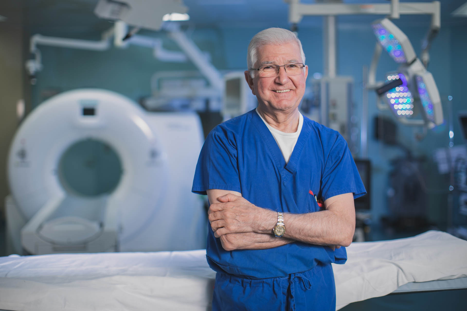 A surgeon standing outside an operating room.