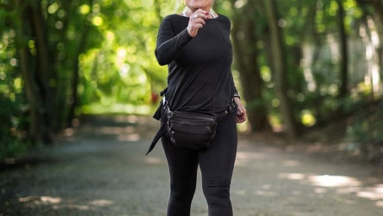 Patient Sharyn Shell, 67, walking along a path outdoors in Toronto