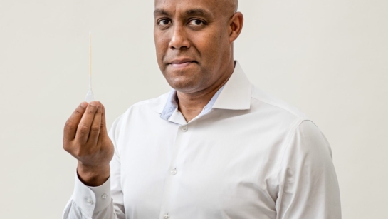 Dr. Hance Clarke, holding a pipette of CBD, is looking at how medical cannabis products manage pain.