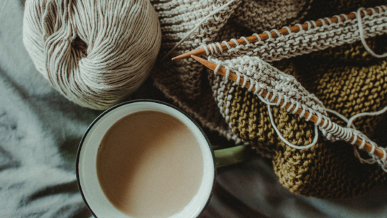 Winter wellness tips (image of knitting needles, yarn and a cup of coffee)