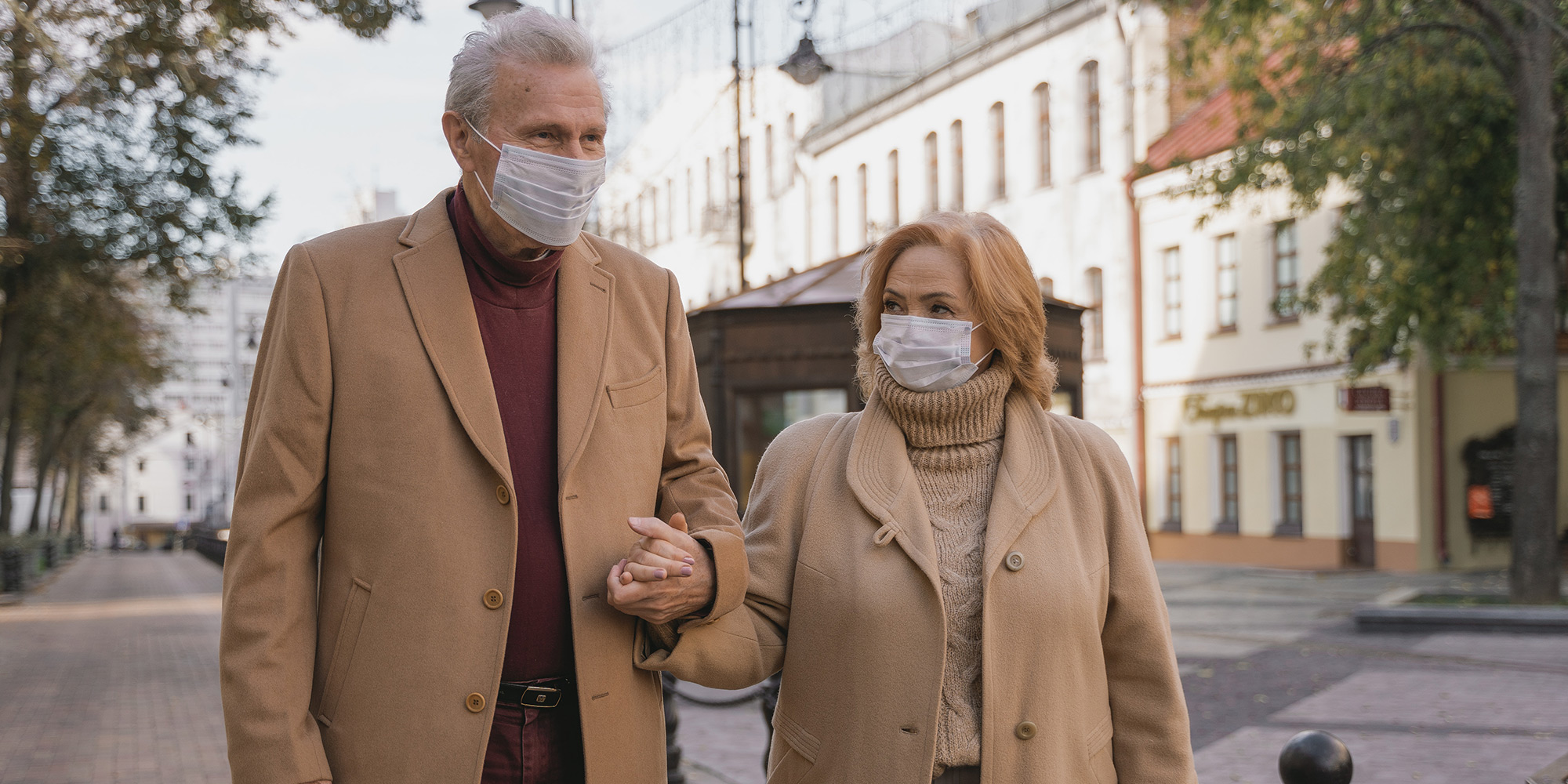 Find connection (image: one male and one female, seniors, masked and going for a walk in the mid-afternoon)