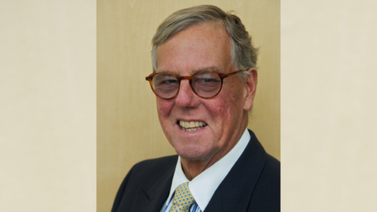 Close up photo of Fred Eaton, he is smiling and wearing a suit