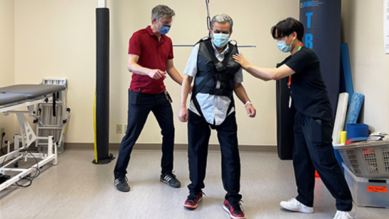 Lou Biasin (L), a physiotherapist in Toronto Rehab's Stroke Inpatient Service, and PT student Christian Martin, (R), use perturbation-based training to help patient Fatah Abdul regain reactive balance control following his stroke.