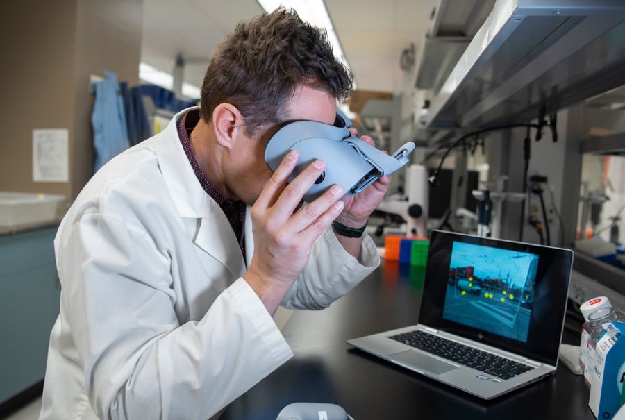 Dr. Michael Reber looks through a head-mounted display called Oculus Go.