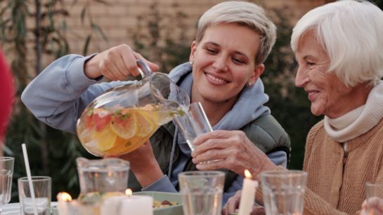 A family enjoying a meal outside in fall weather