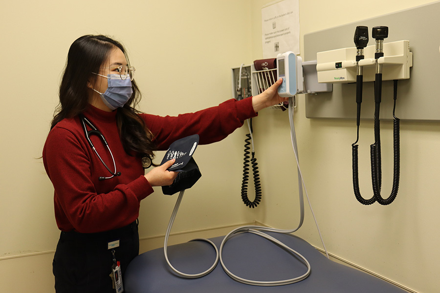 Mandy Yuen prepares equipment in a hospital room. 