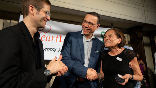 Dr. Mike McDonald and Dr. Robert Cusimano congratulate Mary Markidis