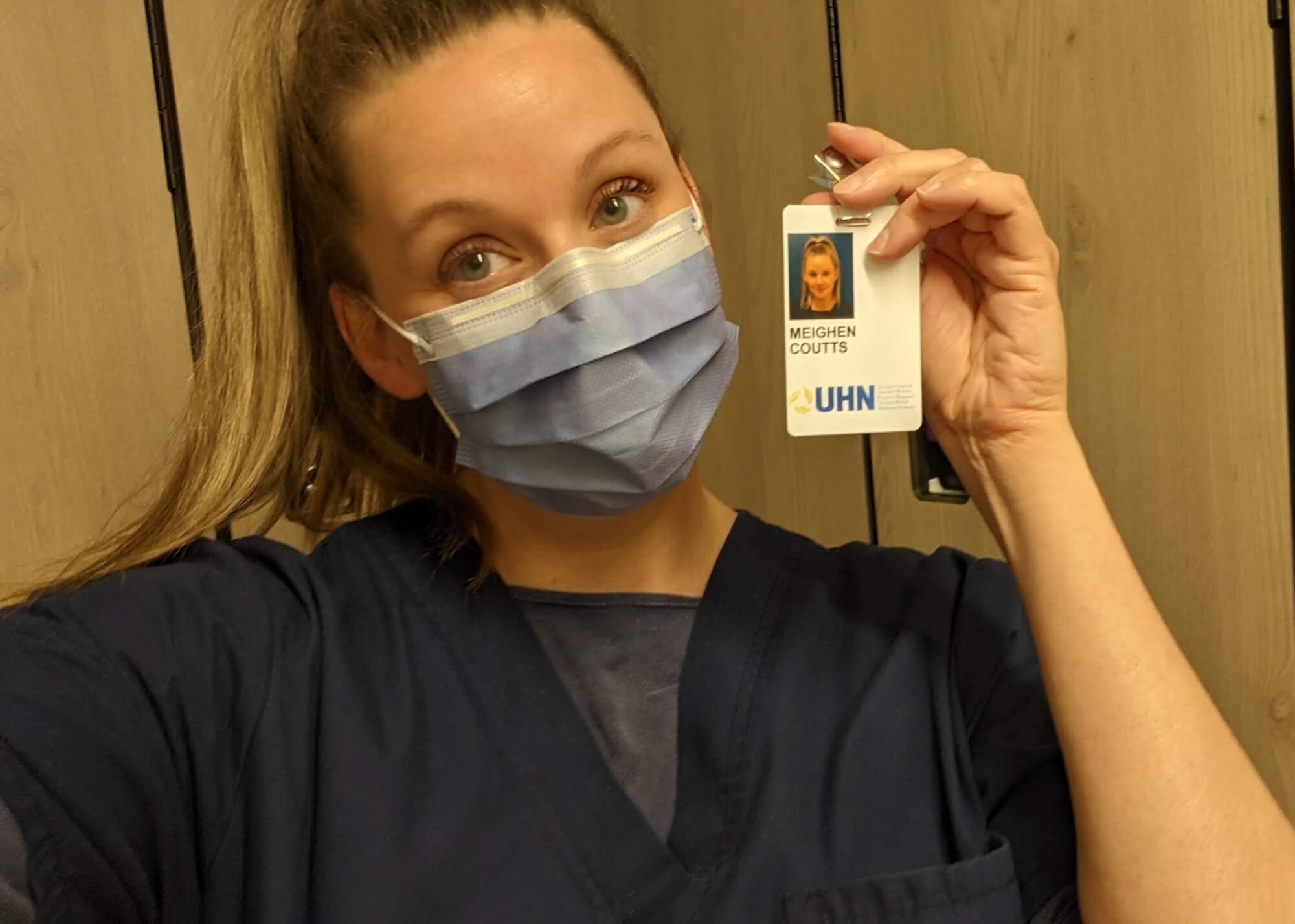 Meighen Coutts holding her UHN badge