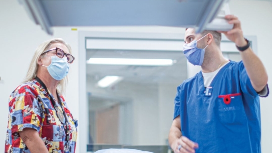 Judy Gabrys and technician Kevin Lavoie use CT scans to see the path cancer cells take inside the body.