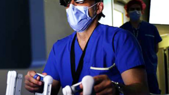 Dr. Tony Finelli, pictured here at the controls of a robot during surgery.