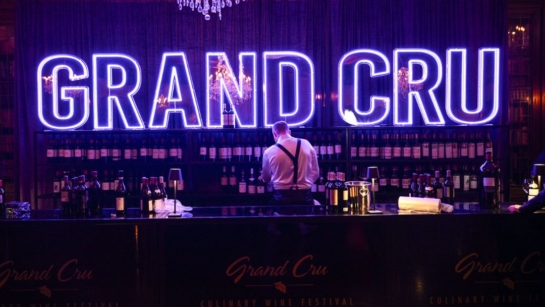 Grand Cru lettering in lights behind a server.