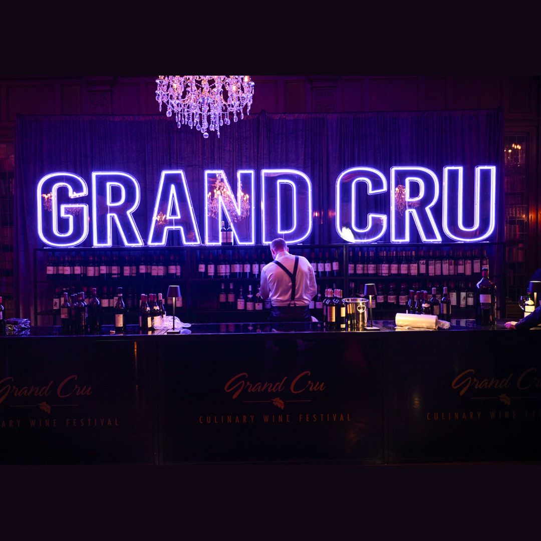 Grand Cru lettering in lights behind a server.