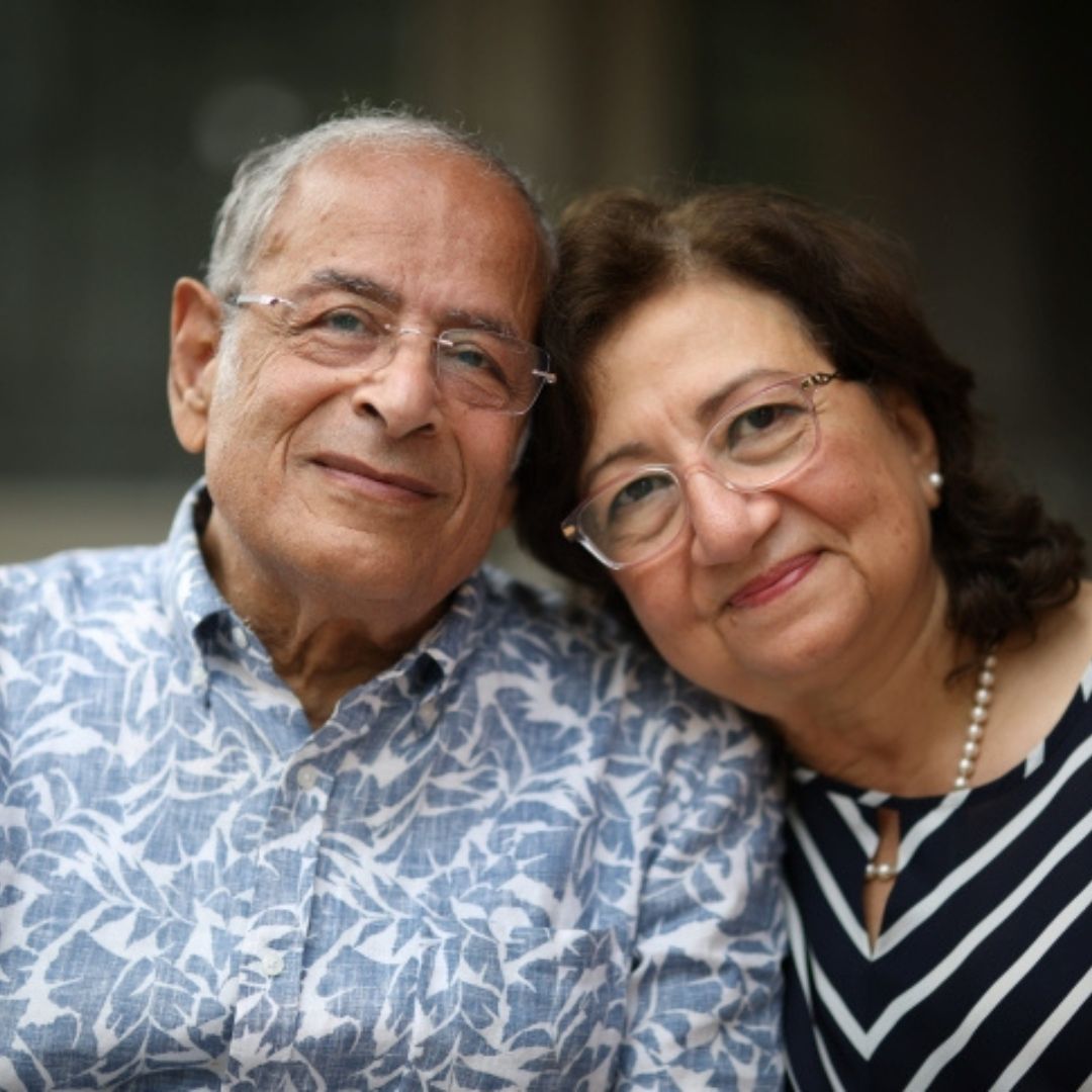 A couple smiling together outside