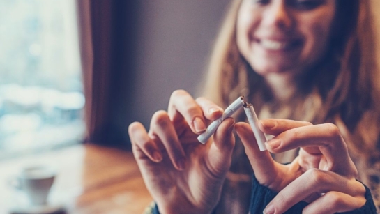 A person breaking a cigarette