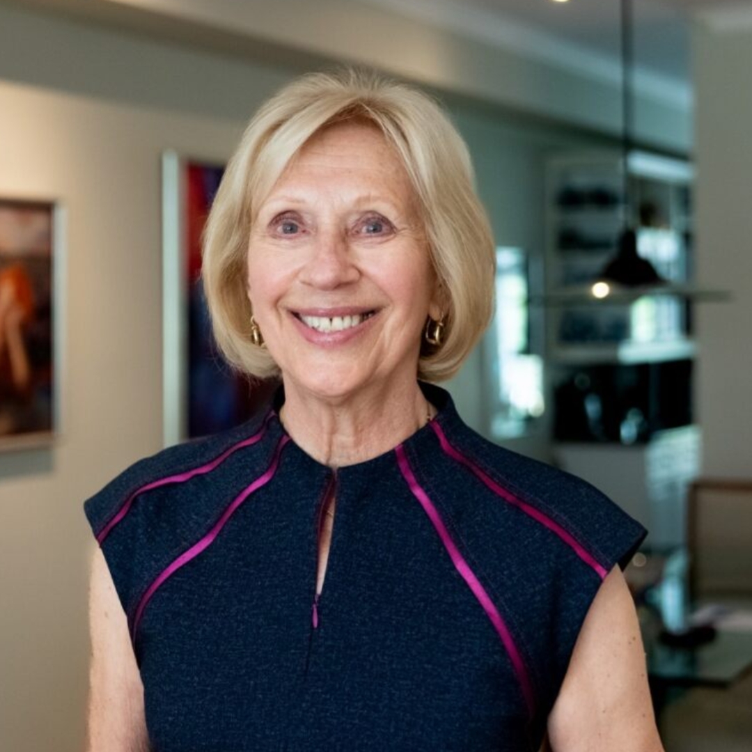 Marvi Ricker smiling in her living room while looking directly at the camera