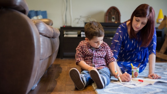 A mother colouring with her son