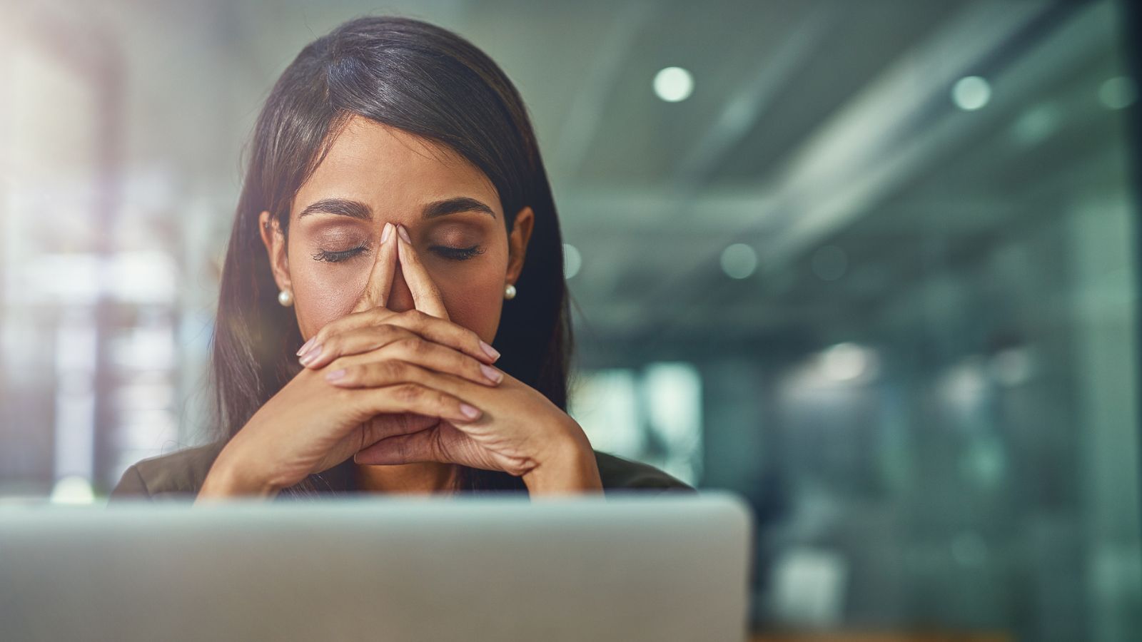 A lady at her desk needing some sleep