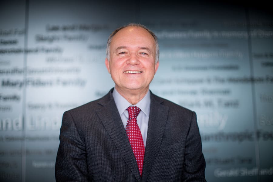 Dr. Donald Weaver, from UHN's Krembil Research Institute smiling in front of a glass window.