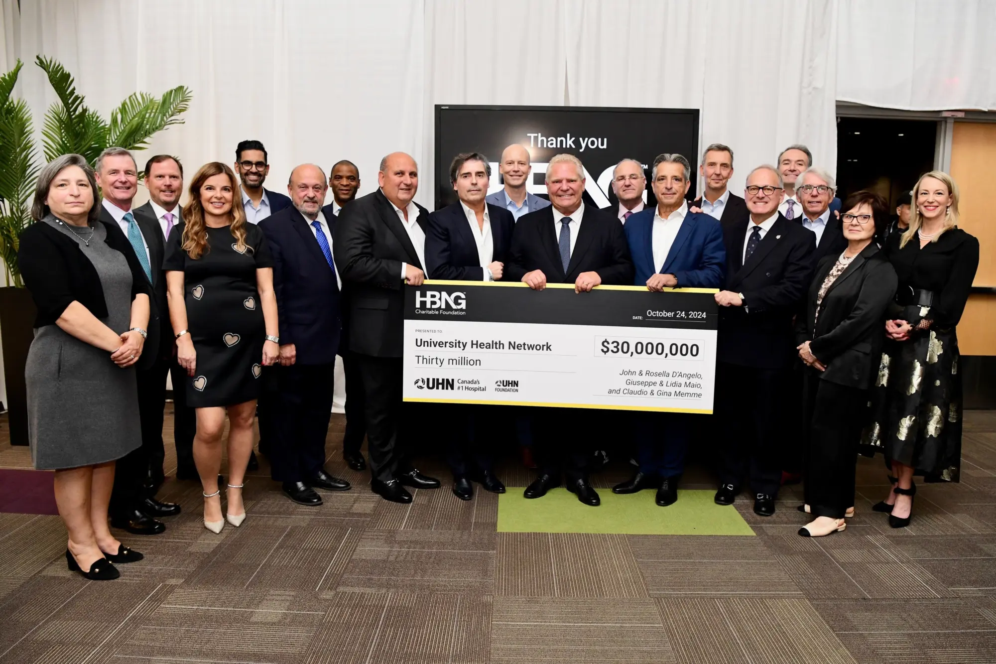 Photo of Premier Doug Ford, donors and UHN Foundation team members holding a large $30 million cheque