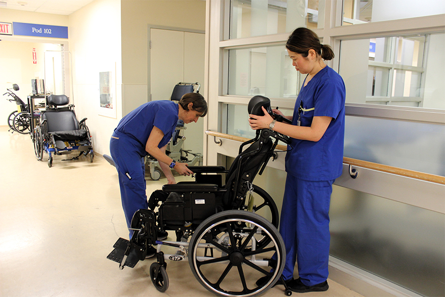 Two UHN occupational therapists setting up a wheelchair