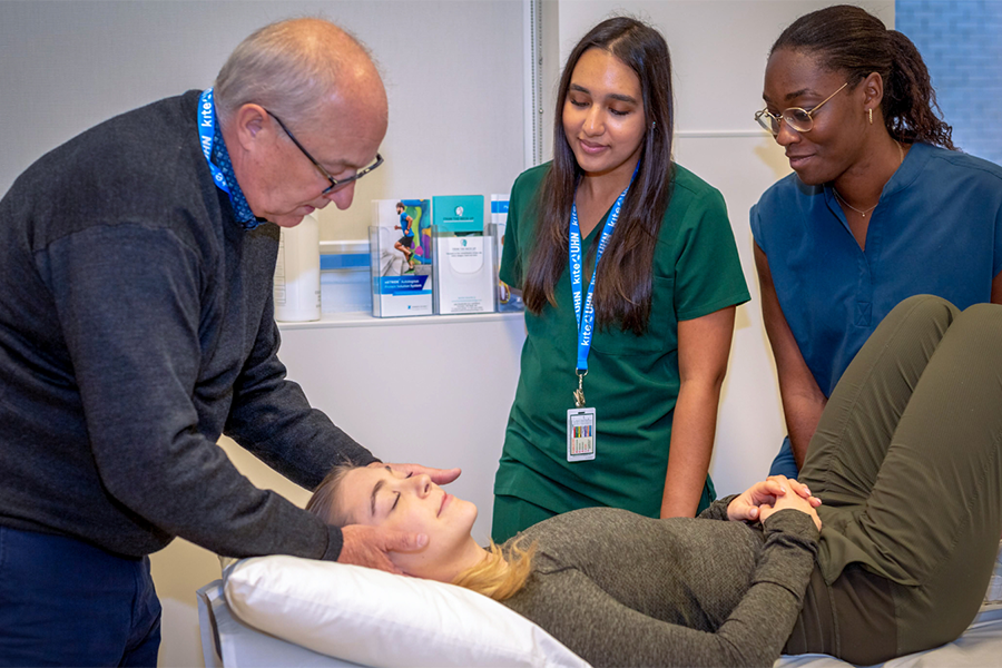 ​​Dr. Ted Crowther, (L), Director of Clinical Education & Patient Care at the Canadian Memorial Chiropractic College, demonstrates the proper technique for students.