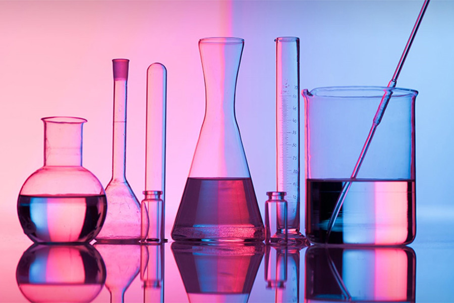 Science glassware with a pink background