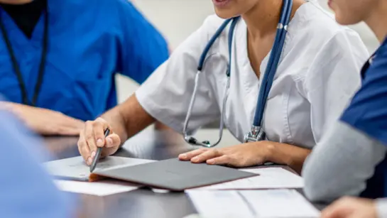 Health professionals going over paperwork at a table