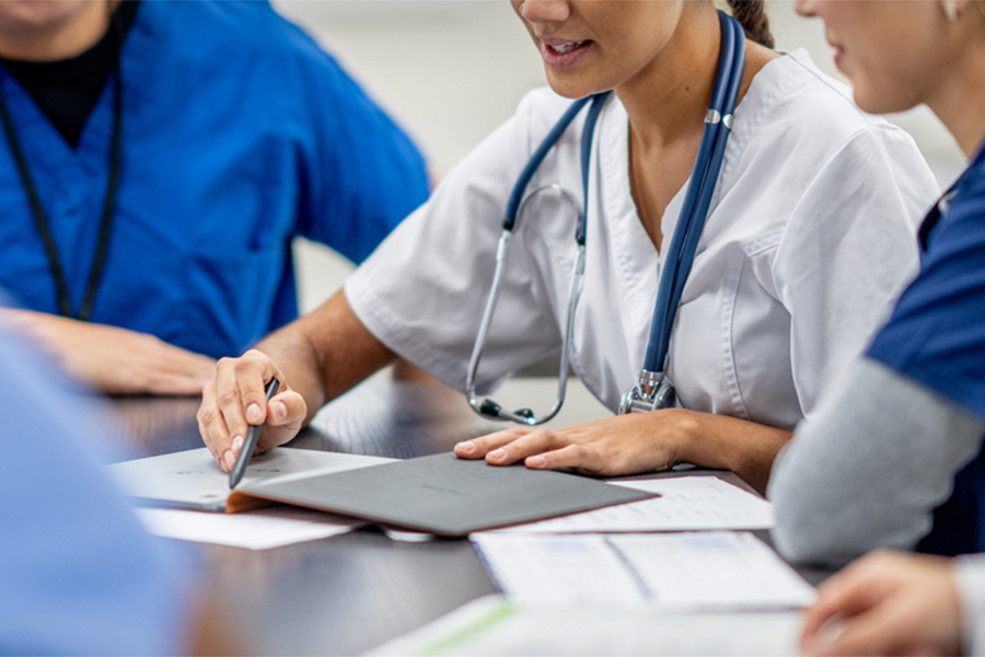 Health professionals going over paperwork at a table