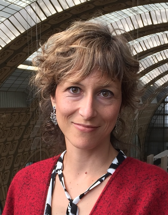 Dr. Ana Konvalinka smiling in an older building with skylights