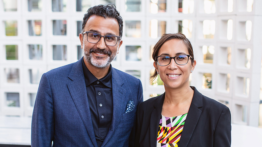 Drs. Suneil Kalia, (L), and Lorraine Kalia (R) smiling while outside together.