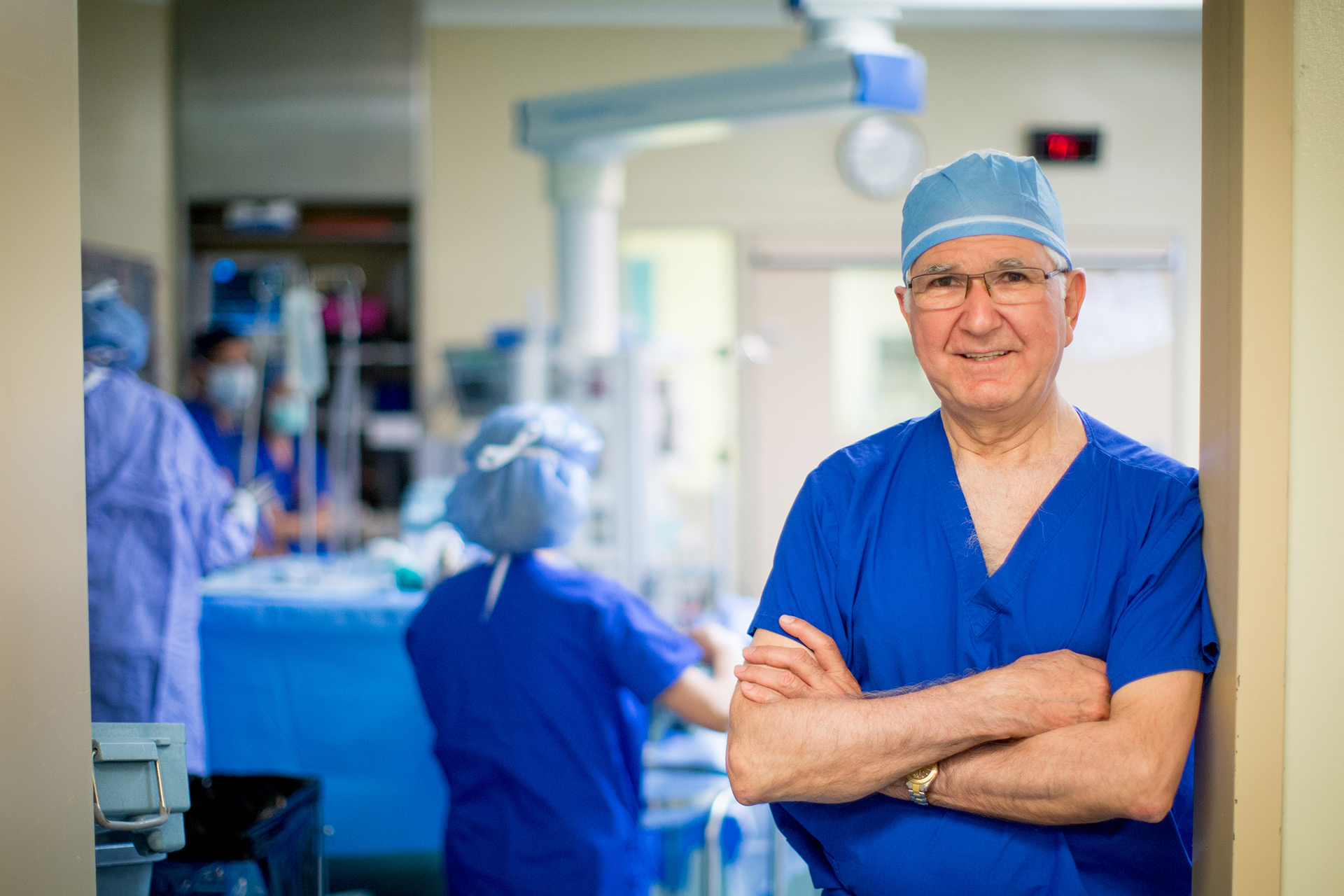A surgeon standing outside an operating room.