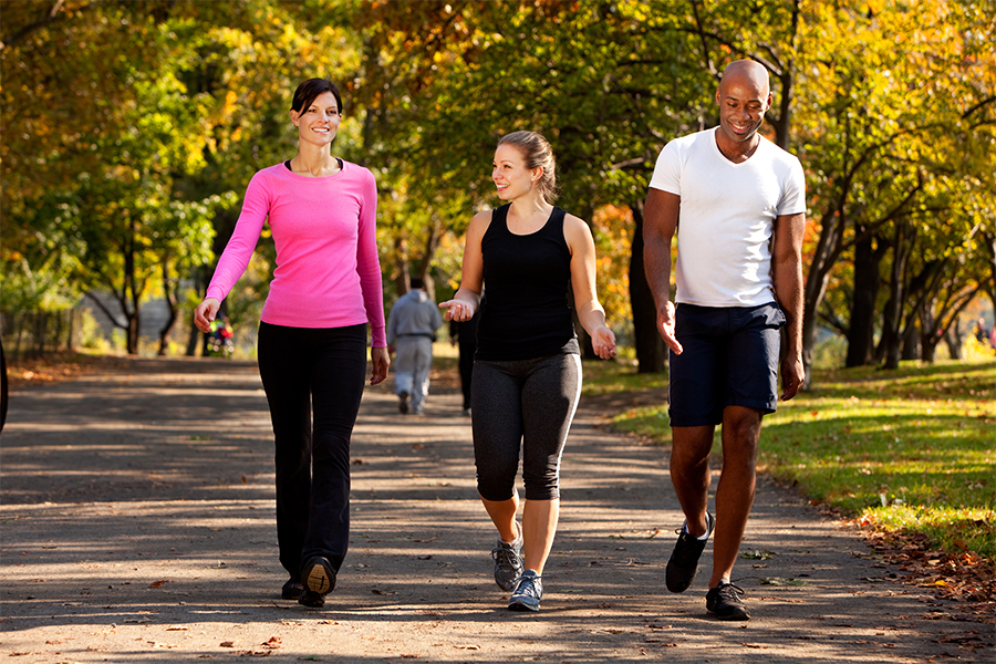 A group jogging together on a path in the sun.