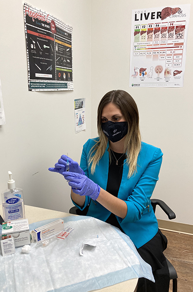 UHN nurse practitioner Dr. Mia Biondi demonstrates the preparation of a hepatitis B vaccine.