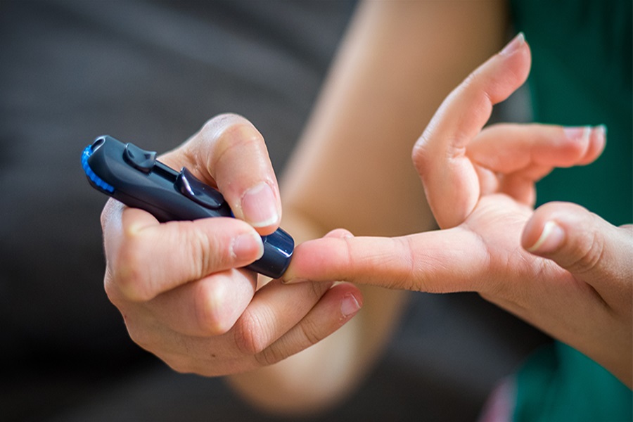A person taking a blood sample for type 1 diabetes.