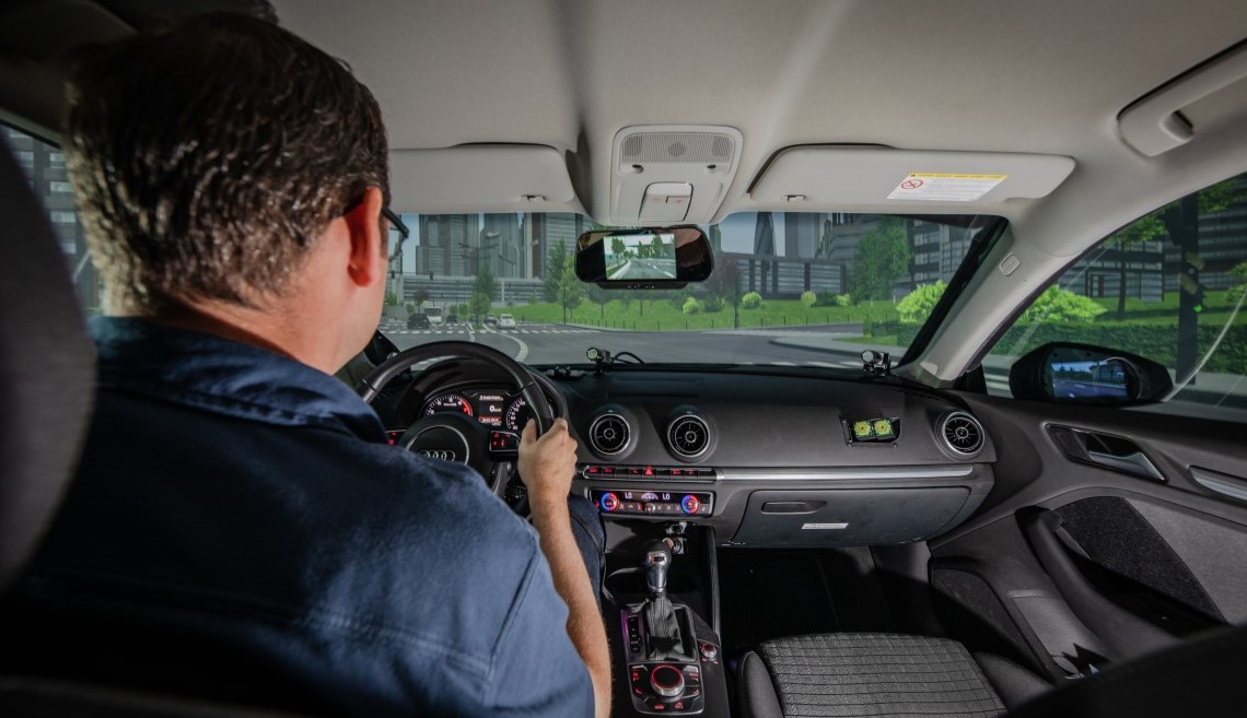 A person behind the wheel in a driving simulation.