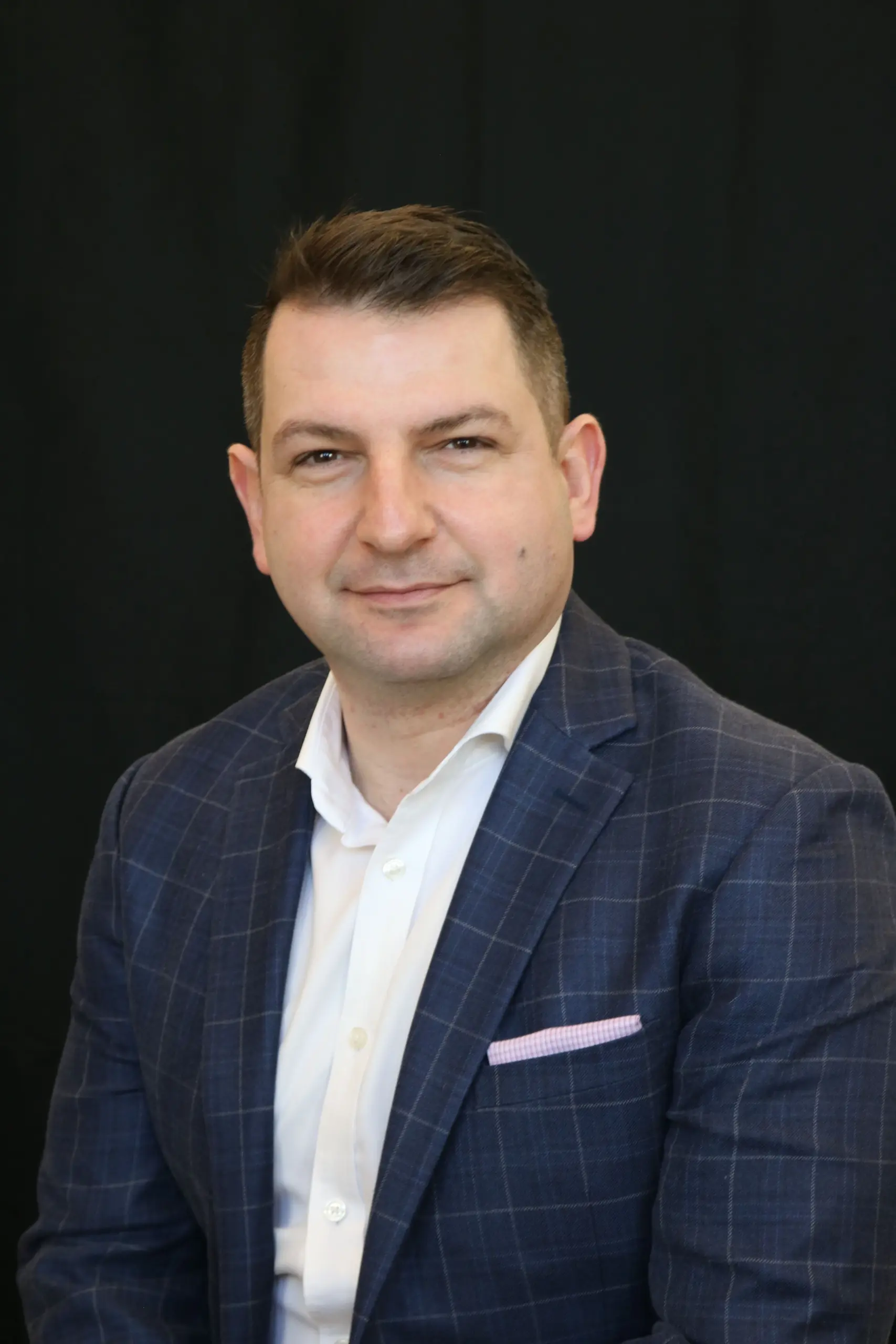 Dr. Andras Fecso portrait photo wearing a suit.