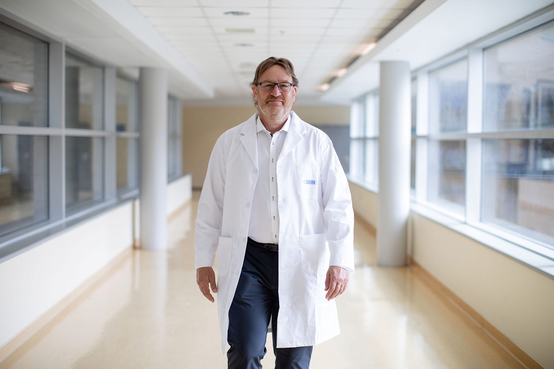 Dr. Gary Lewis at UHN walking in a bright hallway