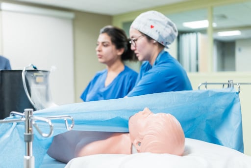 Two health care professionals doing simulation training.