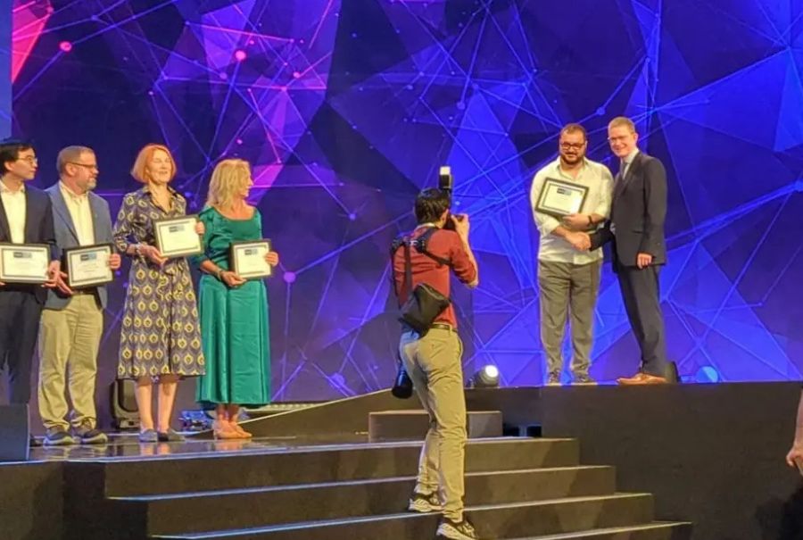 Dr. Kamil Uludag on stage accepting his award.