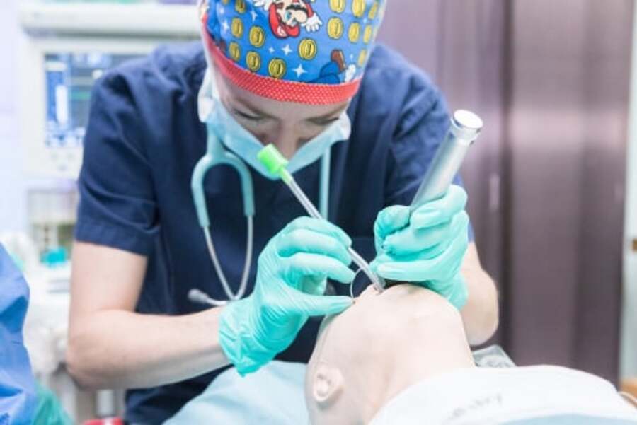Health care worker doing emergency simulation training.