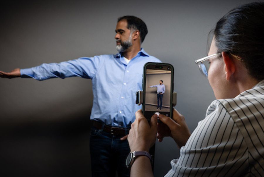Dr. Amol Deshpande, a pain physician and collaborator on the HAT app, demonstrates one of the moves that the app uses to measure hypermobility. (Photo: UHN KITE Research Institute)