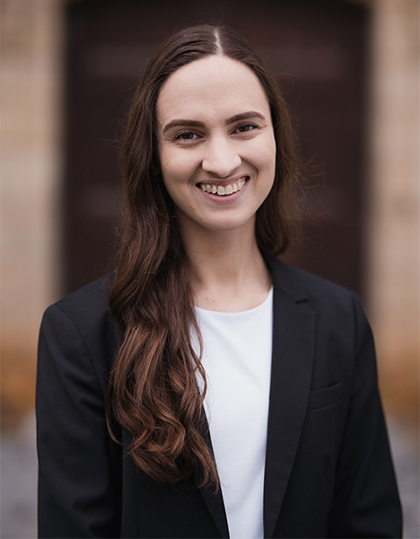 Dr. Candice Richardson smiling while wearing a black coat and white shirt.