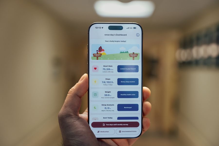 A phone held in a hand showing heart data.