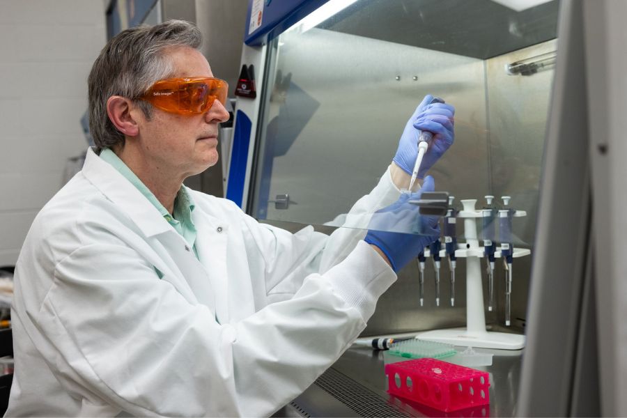 Dr. Mario Ostrowski in a lab with PPE on.