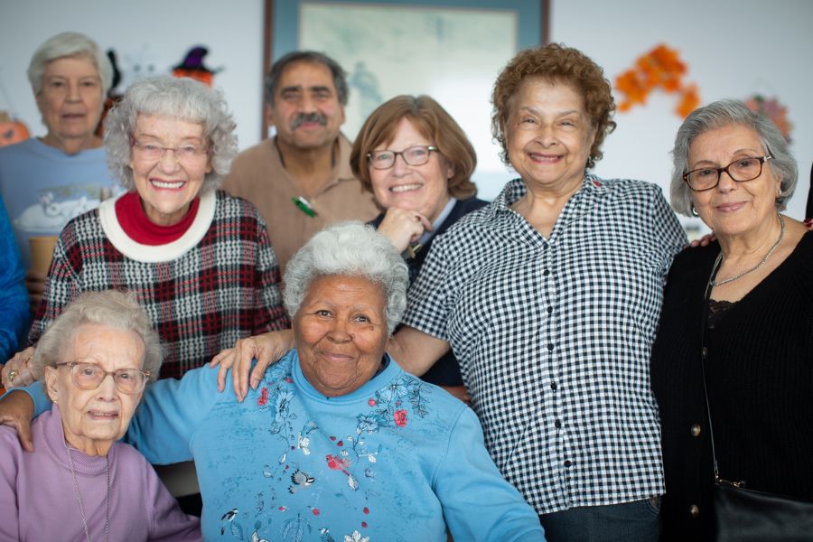 A group of older adults smiling together for a photo.