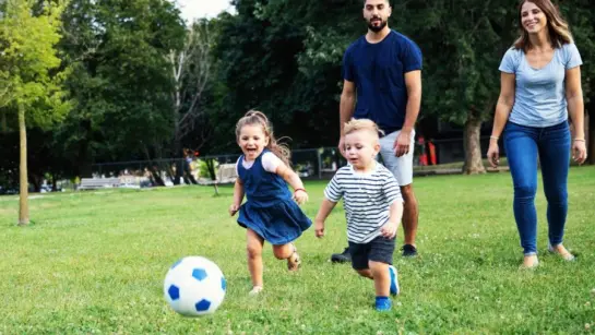 A family playing soccer outdoors