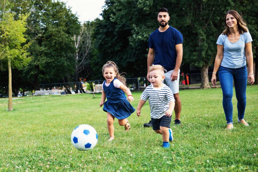 A family playing soccer outdoors
