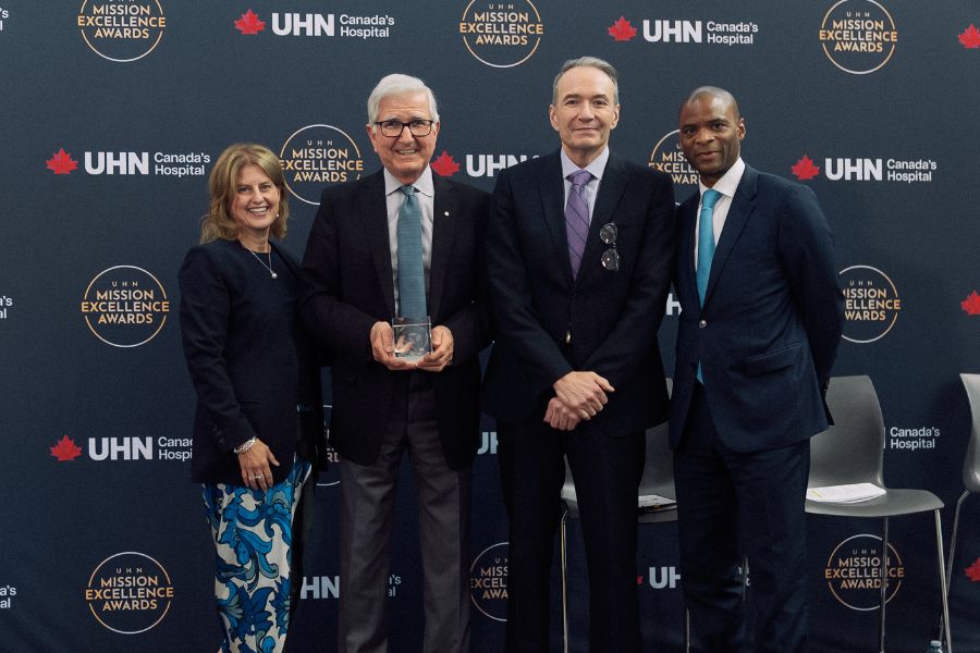 Dr. Tirone David holding his award with UHN leadership.