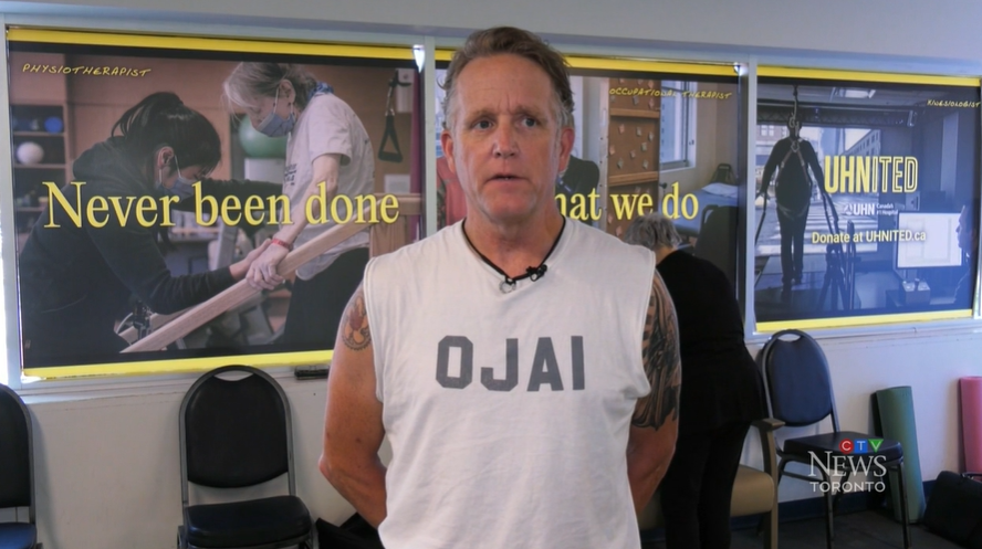Brian Simpson recounting his patient story infront of UHNITED branding