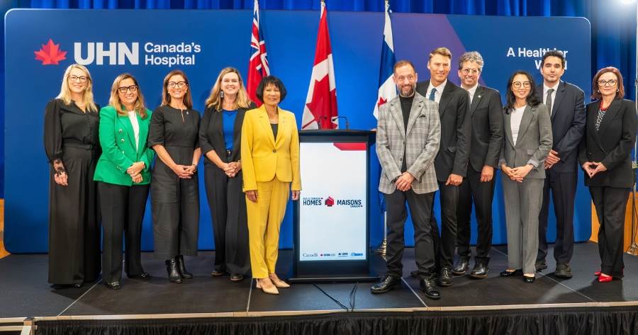 A group photo with UHN leadership, UHN Foundation leadership, municipal, provincial and federal leadership beside the podium of the announcement.
